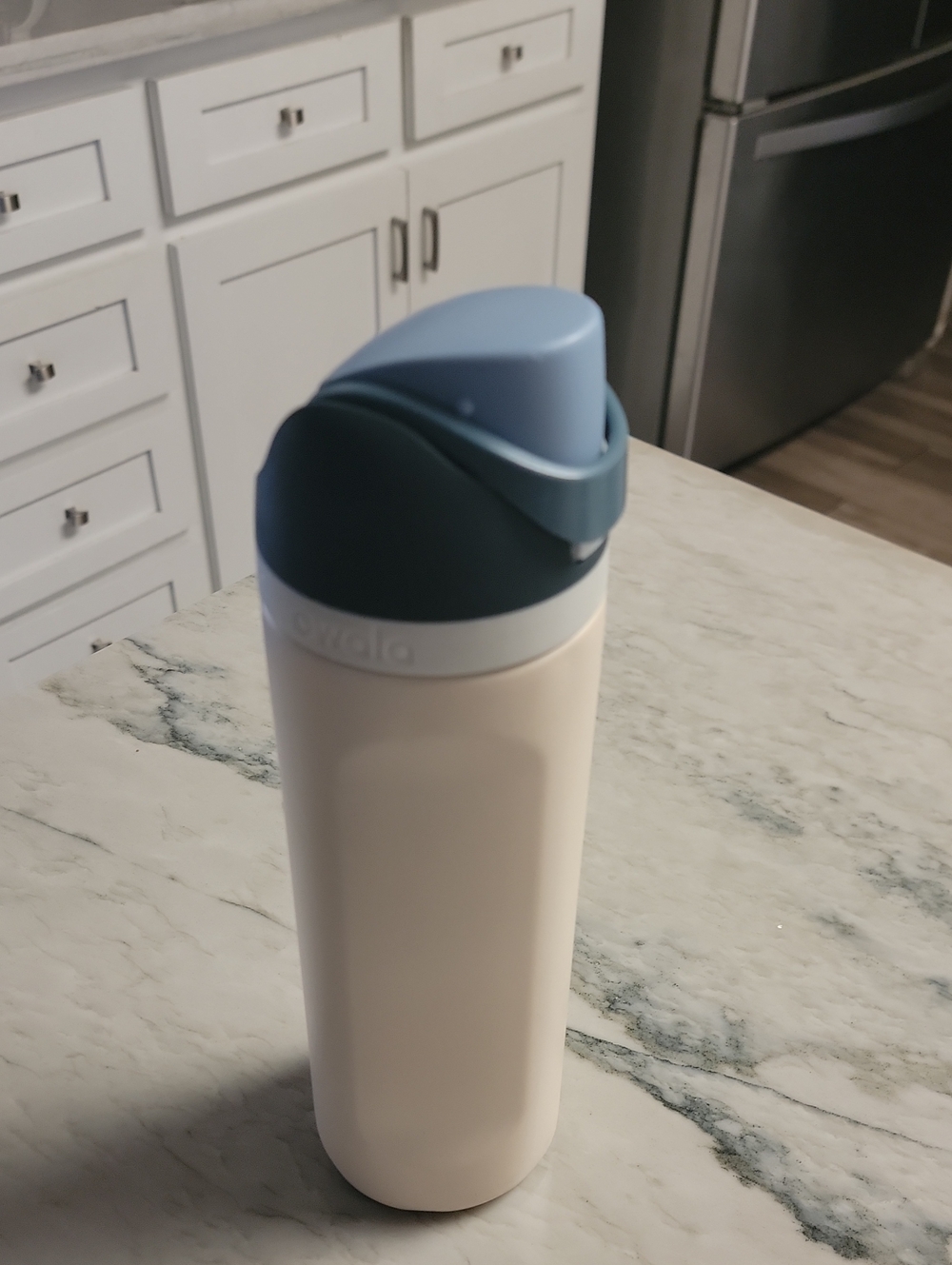 Owala Cream Bottle with Light and Dark Blue Lid